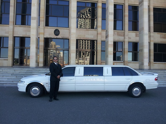 Professional chauffeur opening the door of a black luxury limousine
