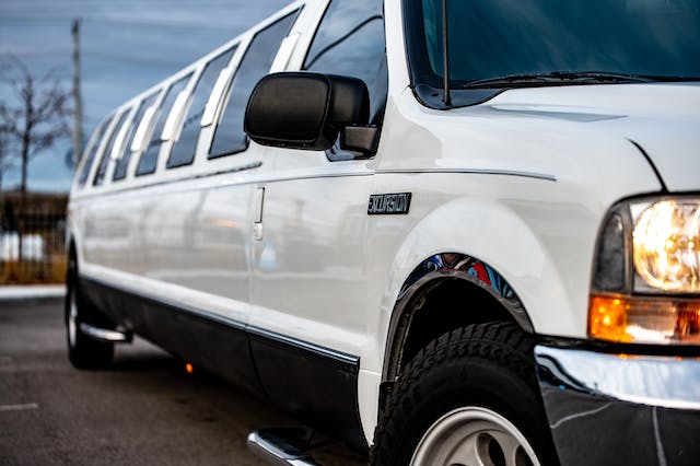 White stretch limousine parked outside an event venue